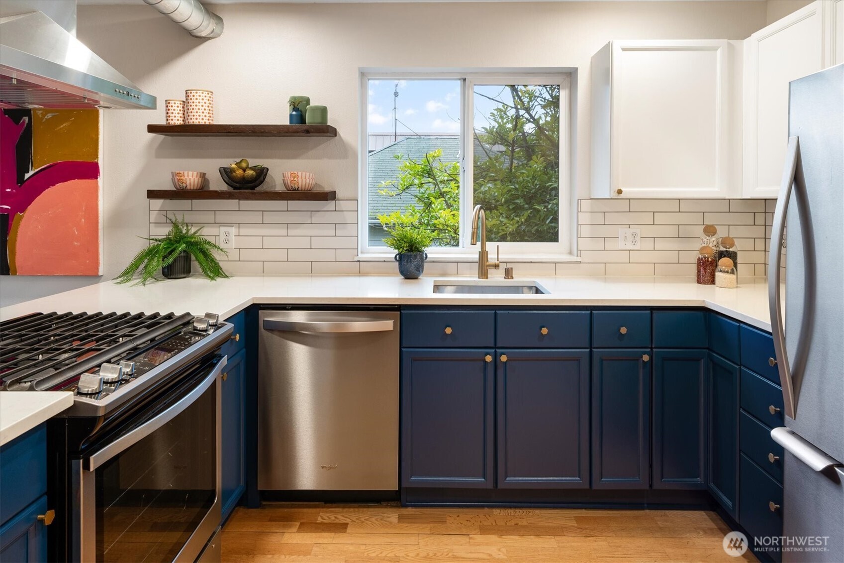 2024 Northwest 57th Street, Unit 201 Seattle, WA 98107 - Photo 14 of 29 a kitchen with stainless steel appliances granite countertop a sink stove and cabinets