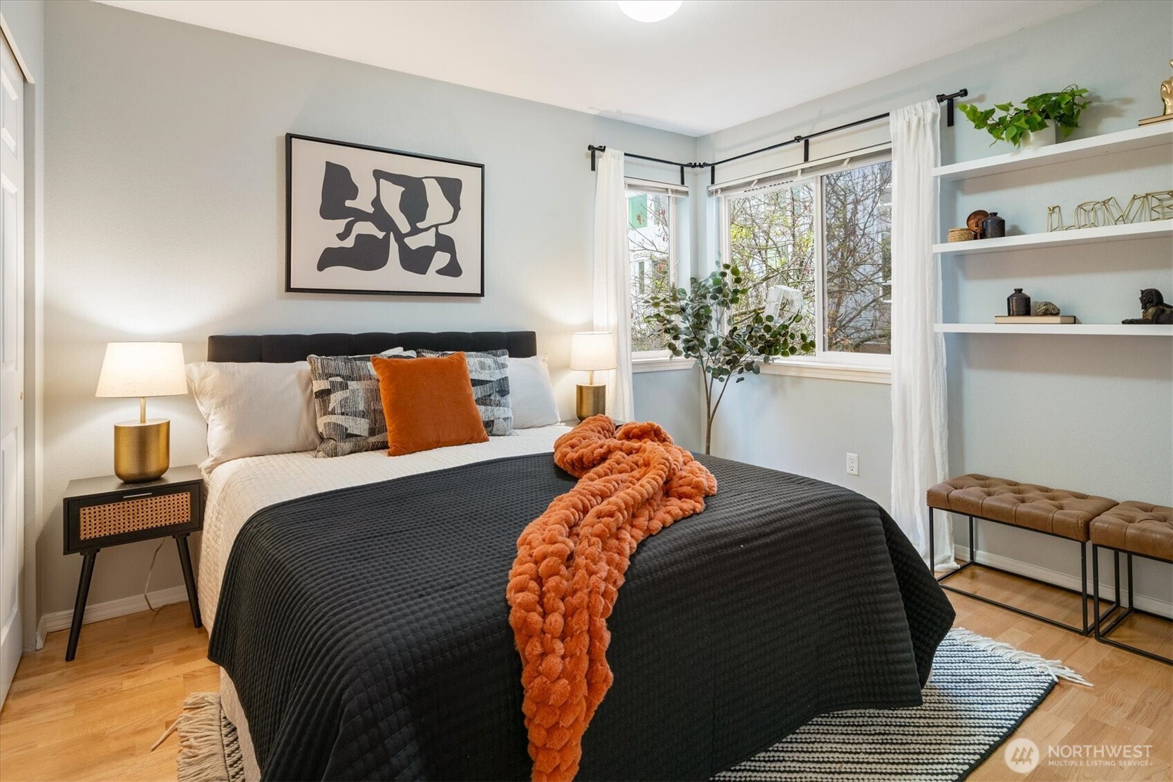 2024 Northwest 57th Street, Unit 201 Seattle, WA 98107 - Photo 15 of 29 a bed sitting in a bedroom next to a window with a lamp and a dresser next to a window