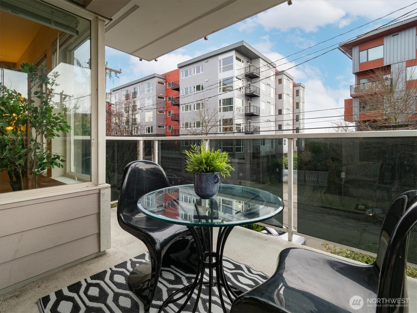 2024 Northwest 57th Street, Unit 201 Seattle, WA 98107 - Photo 8 of 29 a balcony with table and chairs
