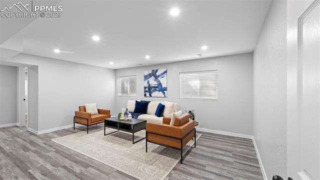 562 Blossom Field Road Fountain, CO 80817 - Photo 19 of 41 Living area with light wood-type flooring and recessed lighting