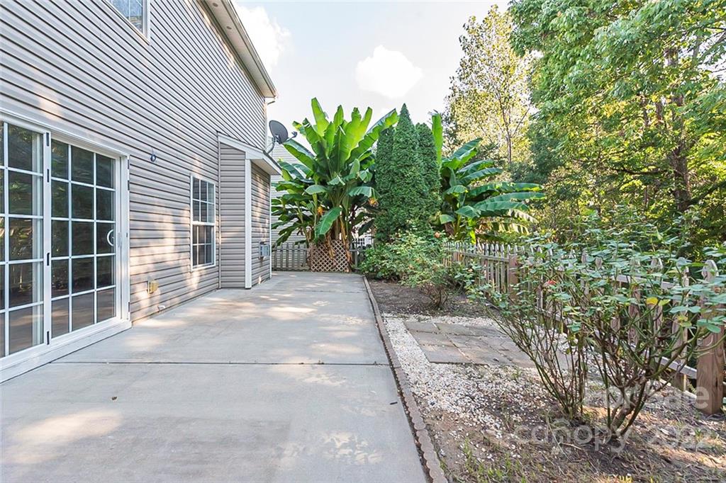 7632 Black Hawk Lane Tega Cay, SC 29708 - Photo 15 of 16 a view of a house with a yard and potted plants
