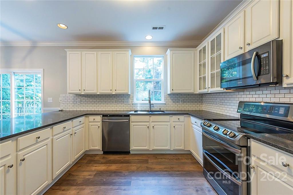 7632 Black Hawk Lane Tega Cay, SC 29708 - Photo 6 of 16 a kitchen with stainless steel appliances granite countertop a stove and cabinets