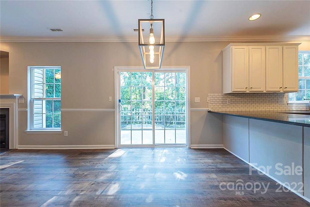 7632 Black Hawk Lane Tega Cay, SC 29708 - Photo 10 of 16 wooden floor in an empty room with a window