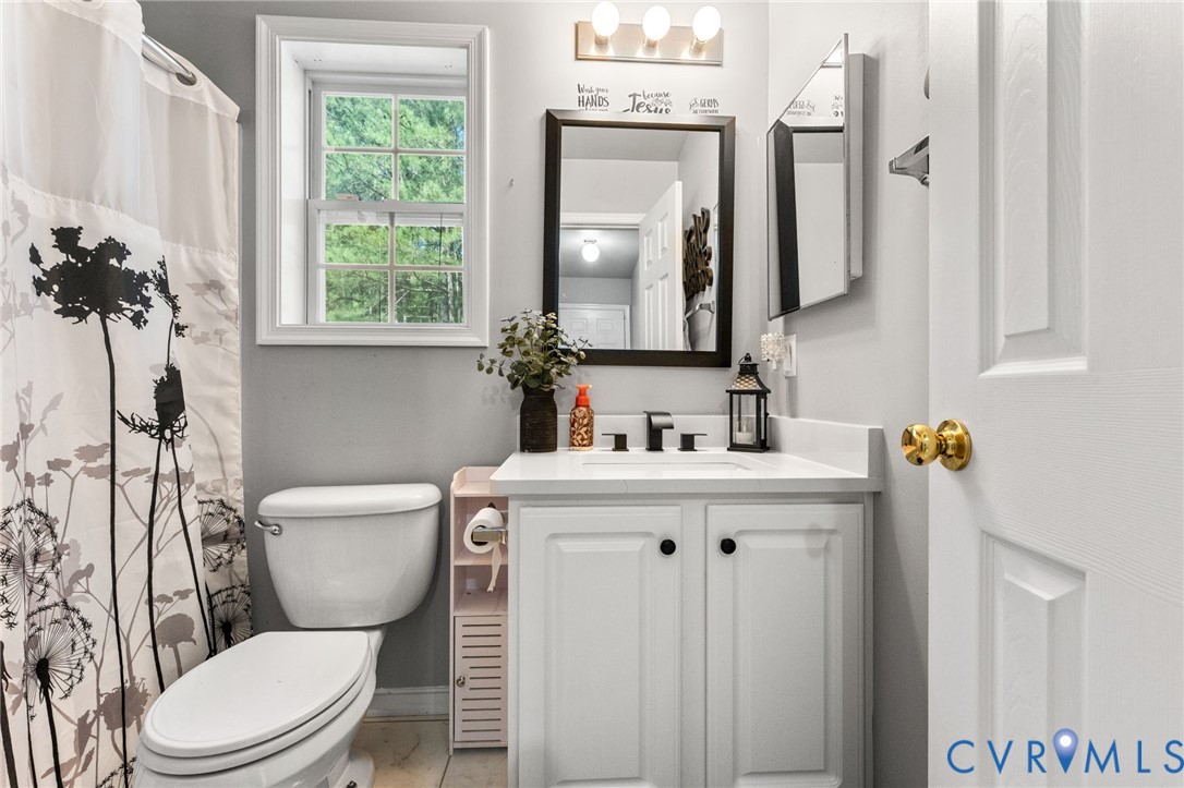3120 Denise Road Petersburg, VA 23805 - Photo 34 of 51 Bathroom featuring a white vanity with panel cabin