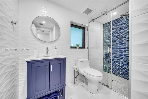 a bathroom with a toilet a sink and mirror