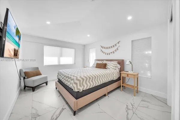 a spacious bedroom with a bed and a couch