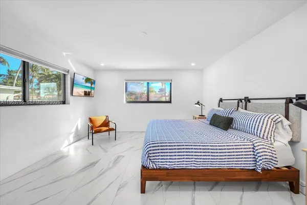 a bedroom with a bed and a potted plant