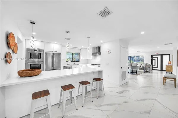 a large kitchen with a table and chairs
