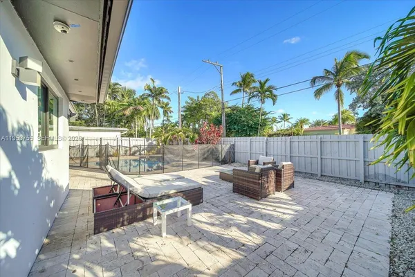 a view of a backyard with sitting area