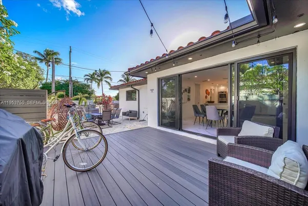 a view of a porch with furniture and wooden floor