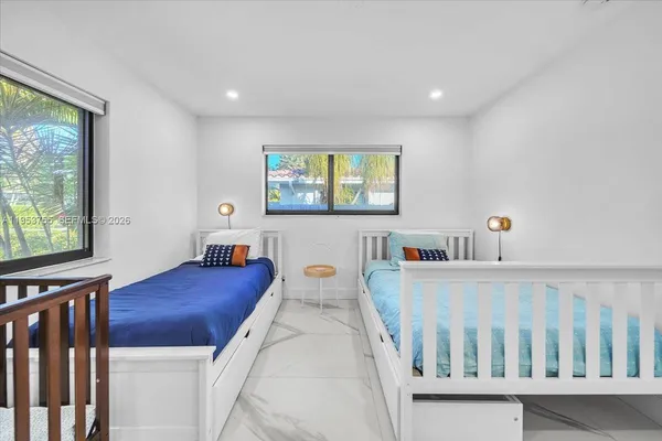 a bedroom with furniture and a window