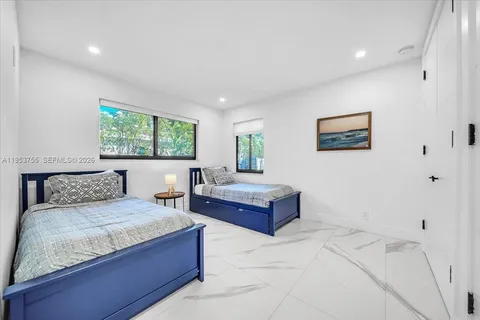 a bedroom with a large bed and a couch