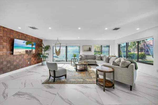 a living room with fireplace furniture and a flat screen tv
