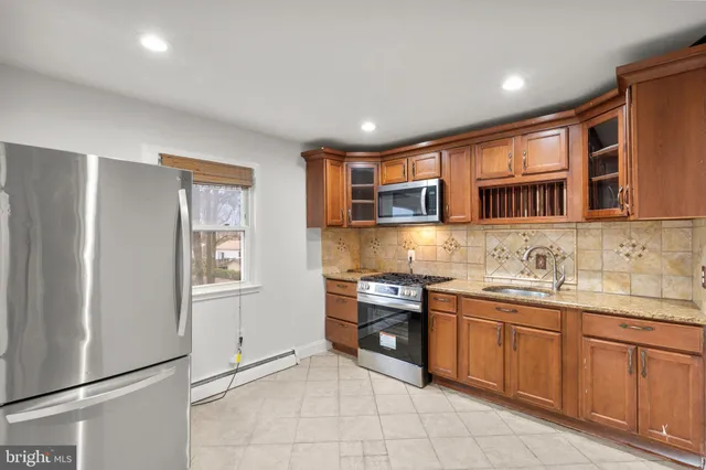 a kitchen with stainless steel appliances granite countertop a stove sink and cabinets