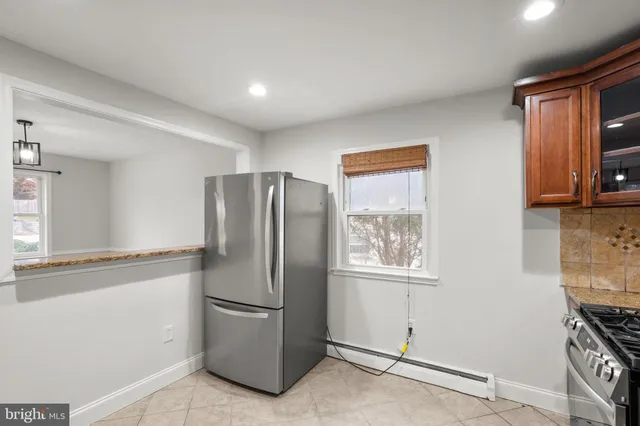 a metallic refrigerator freezer sitting in a kitchen