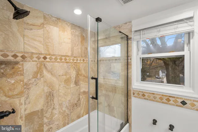 a bathroom with a shower and a window