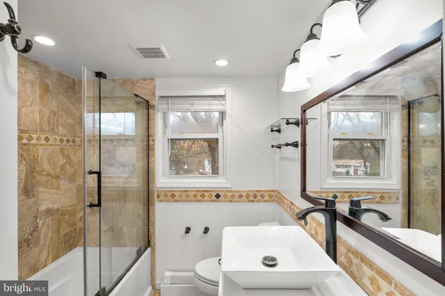 a bathroom with a bathtub a shower a sink and mirror