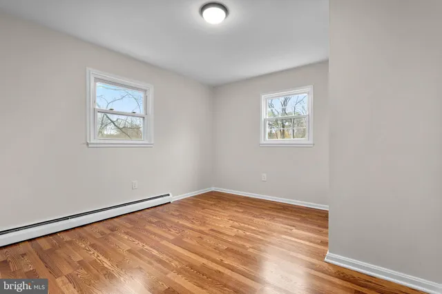 an empty room with a workspace and a window