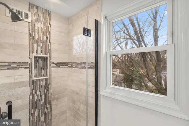 a bathroom with a window and a shower