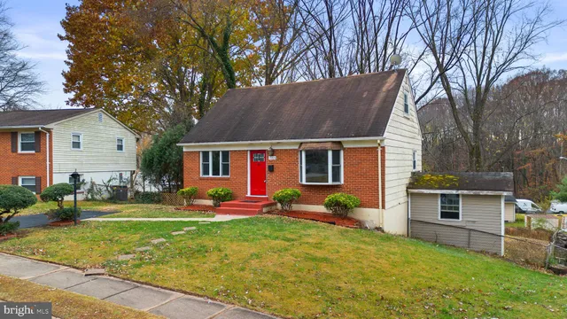 a front view of house with yard and outdoor seating