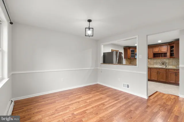 a bedroom with a bed and a view of kitchen