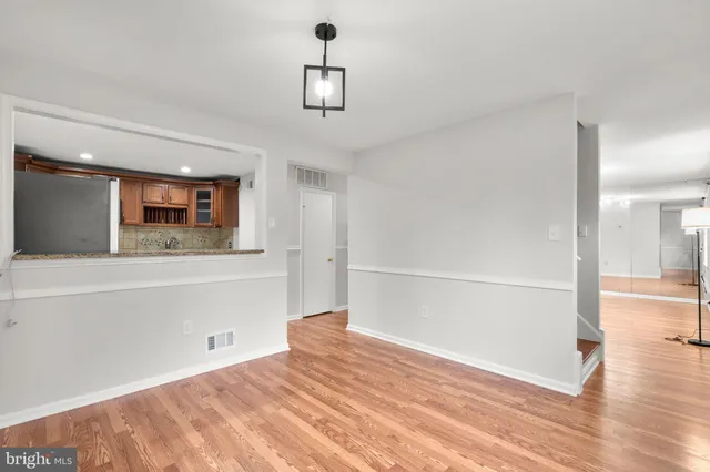 a view of a room with wooden floor and staircase