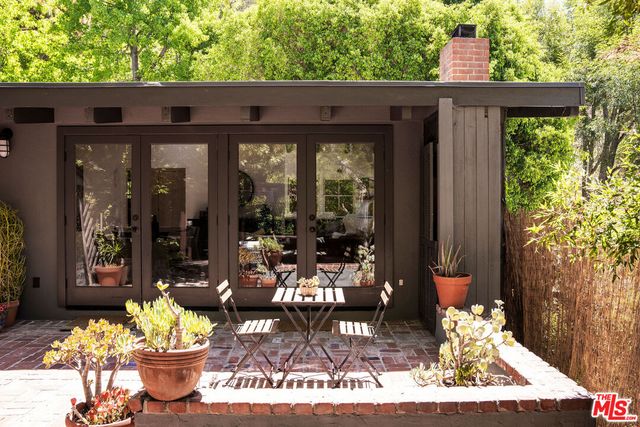 a view of a patio with table and chairs and potted plants