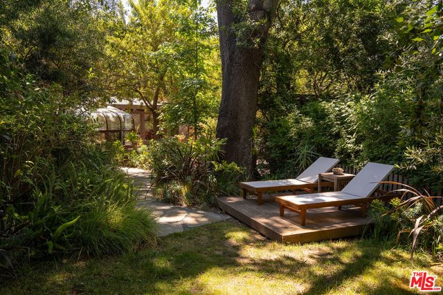 a backyard of a house with table and chairs