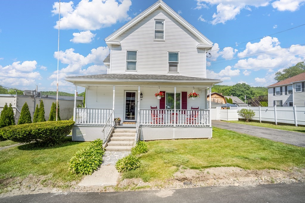 a view of a house with a yard and plants