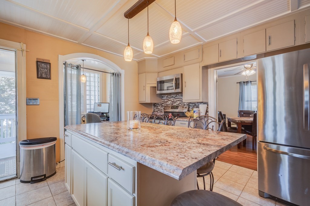 39 Hardwick Road Hardwick, MA 01031 - Photo 13 of 27 a kitchen with a table chairs refrigerator and microwave