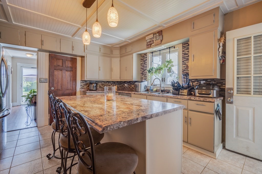 39 Hardwick Road Hardwick, MA 01031 - Photo 15 of 27 a kitchen with stainless steel appliances granite countertop a sink a stove and chairs