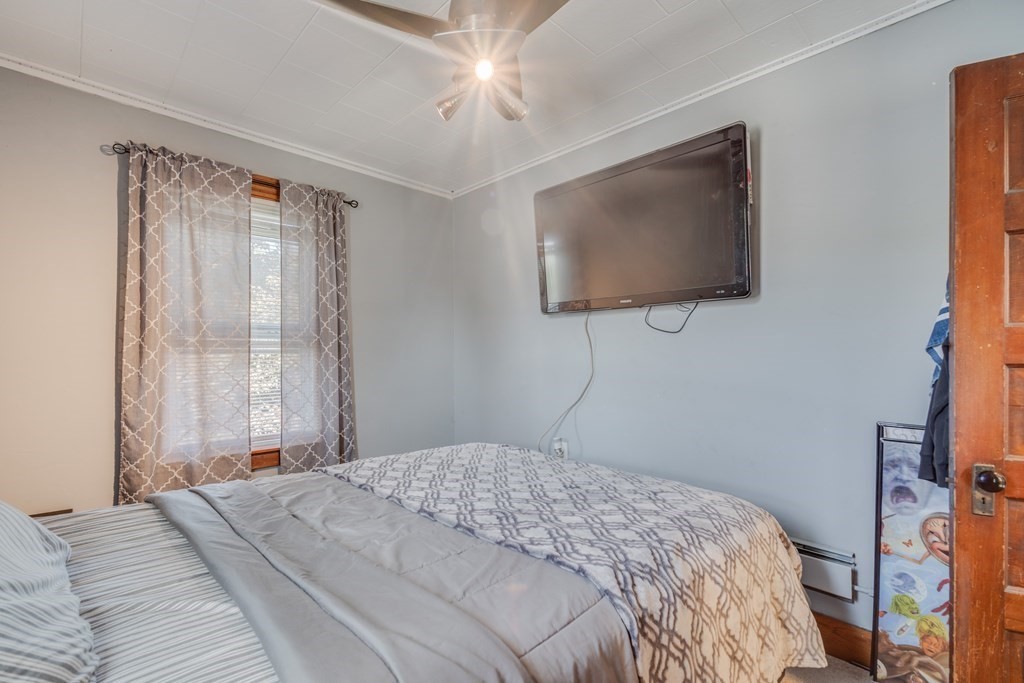 39 Hardwick Road Hardwick, MA 01031 - Photo 20 of 27 a bedroom with a bed and a flat screen tv