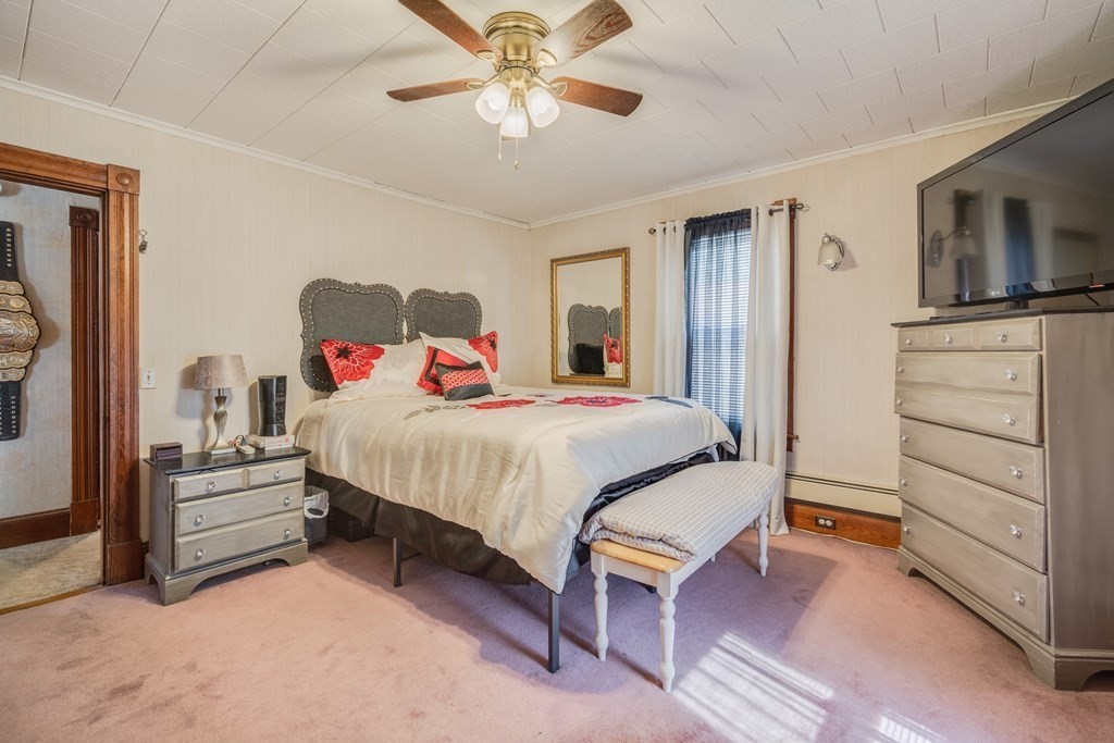 39 Hardwick Road Hardwick, MA 01031 - Photo 23 of 27 a bedroom with a bed and a chandelier