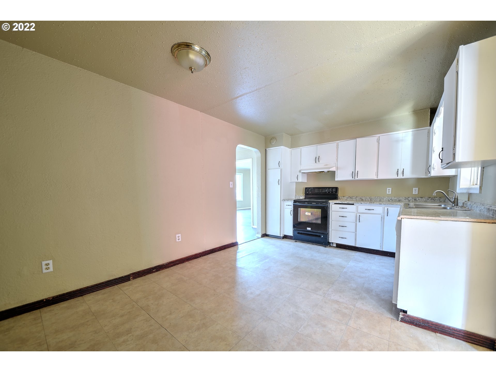 1273 Modoc Street Springfield, OR 97477 - Photo 13 of 16 a open kitchen with cabinets and a wooden floor