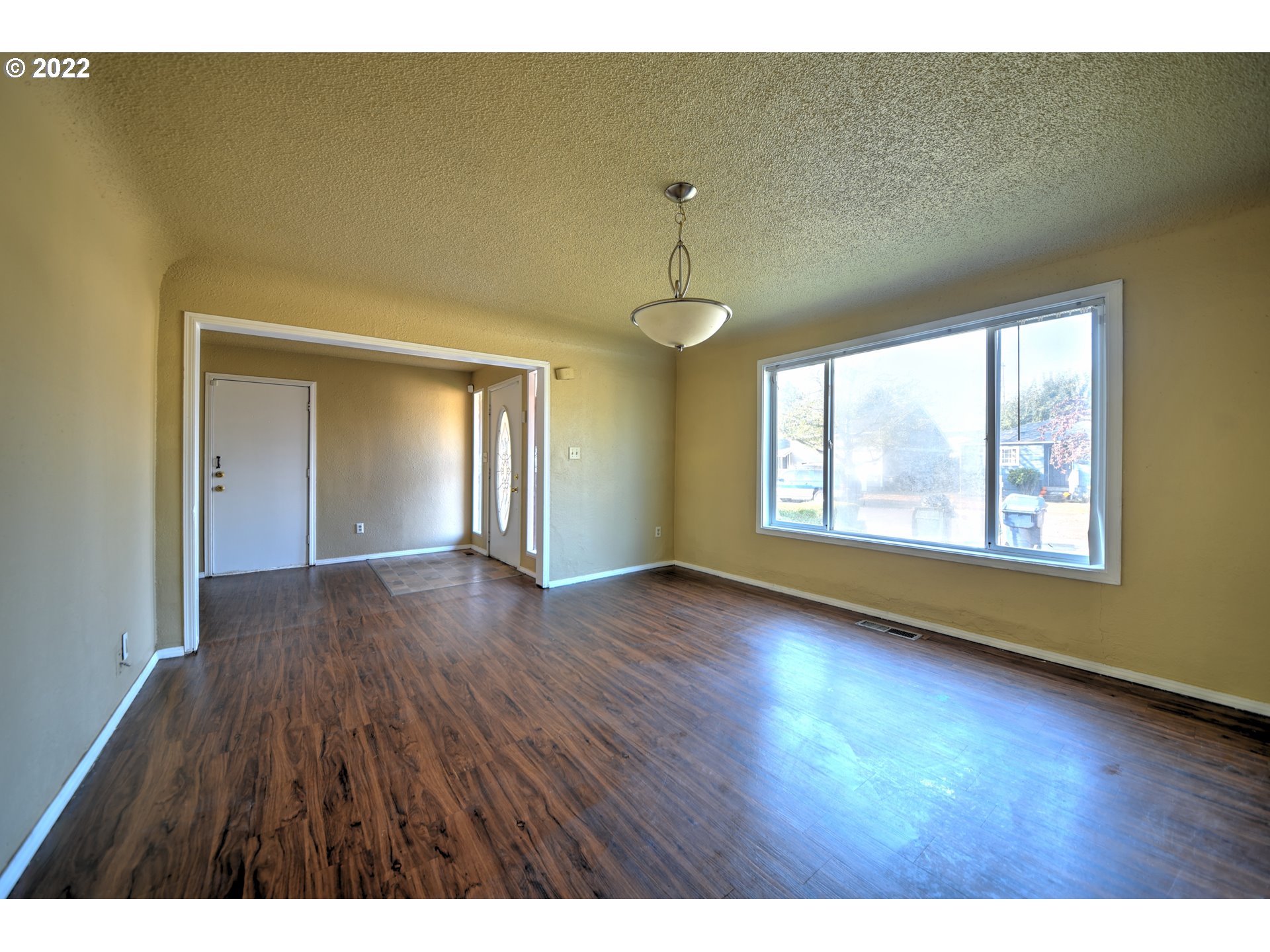 1273 Modoc Street Springfield, OR 97477 - Photo 3 of 16 a view of an empty room with wooden floor and a window