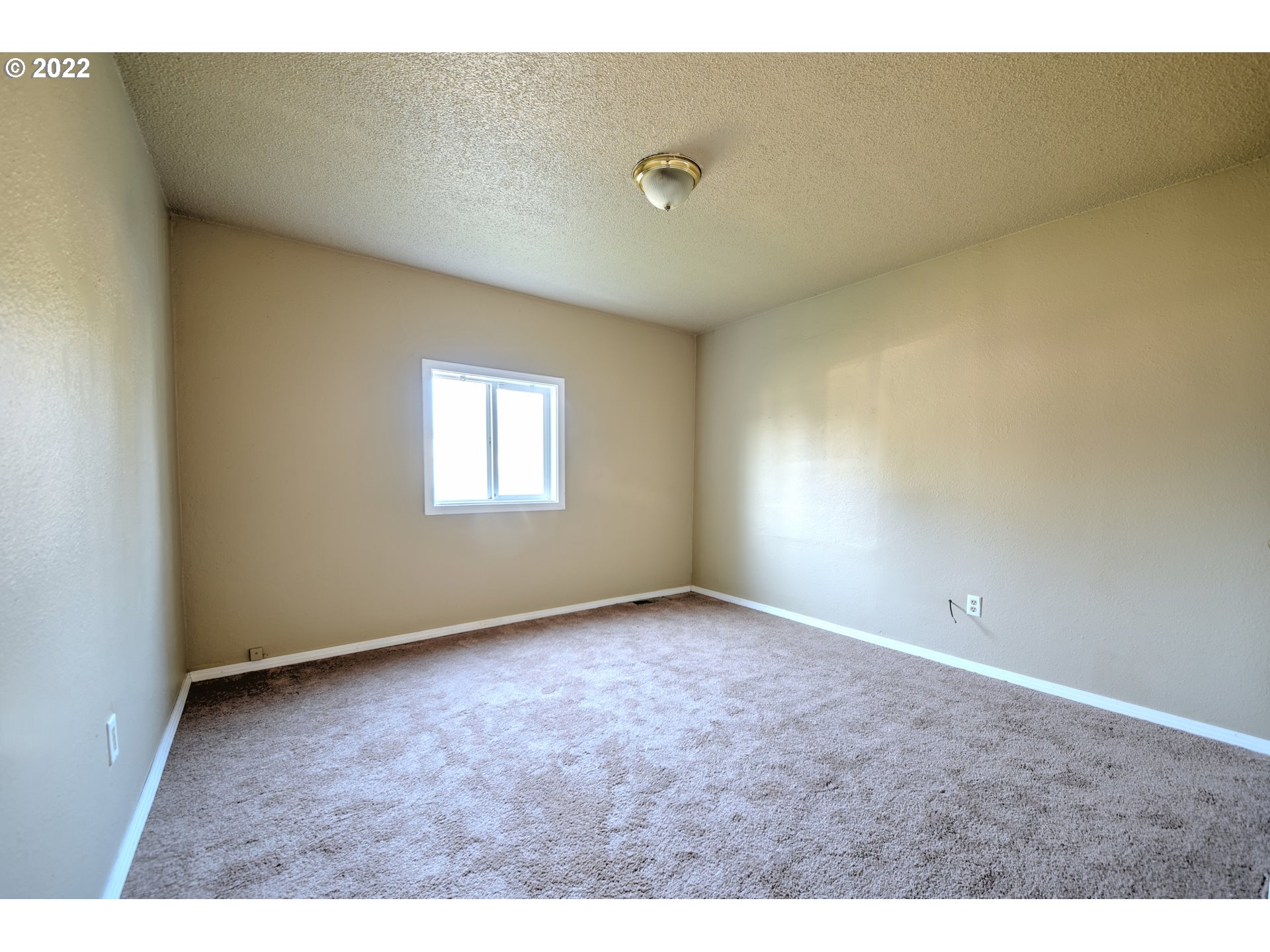 1273 Modoc Street Springfield, OR 97477 - Photo 4 of 16 a view of an empty room with a window