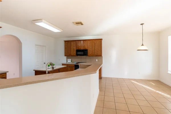 a kitchen with a sink a counter top space cabinets and appliances