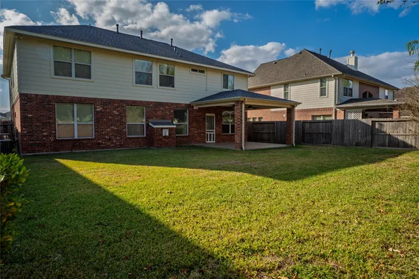 a view of a house with a yard and sitting area
