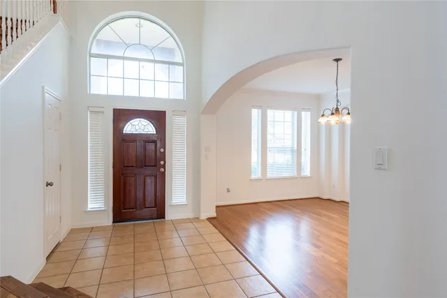 a view of empty room with wooden floor and fireplace