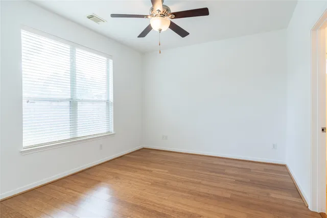 a kitchen with stainless steel appliances granite countertop wooden cabinets a sink a stove a dining table and chairs