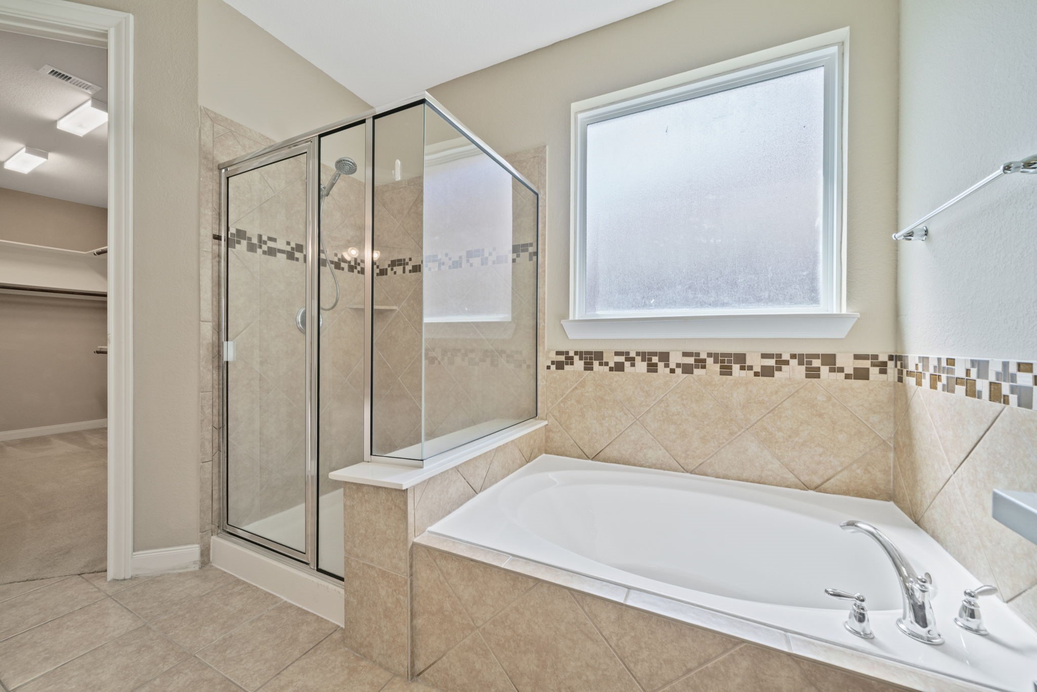 22523 Birch Ridge Meadow Drive Spring, TX 77389 - Photo 23 of 39 a bathroom with a bathtub and a shower