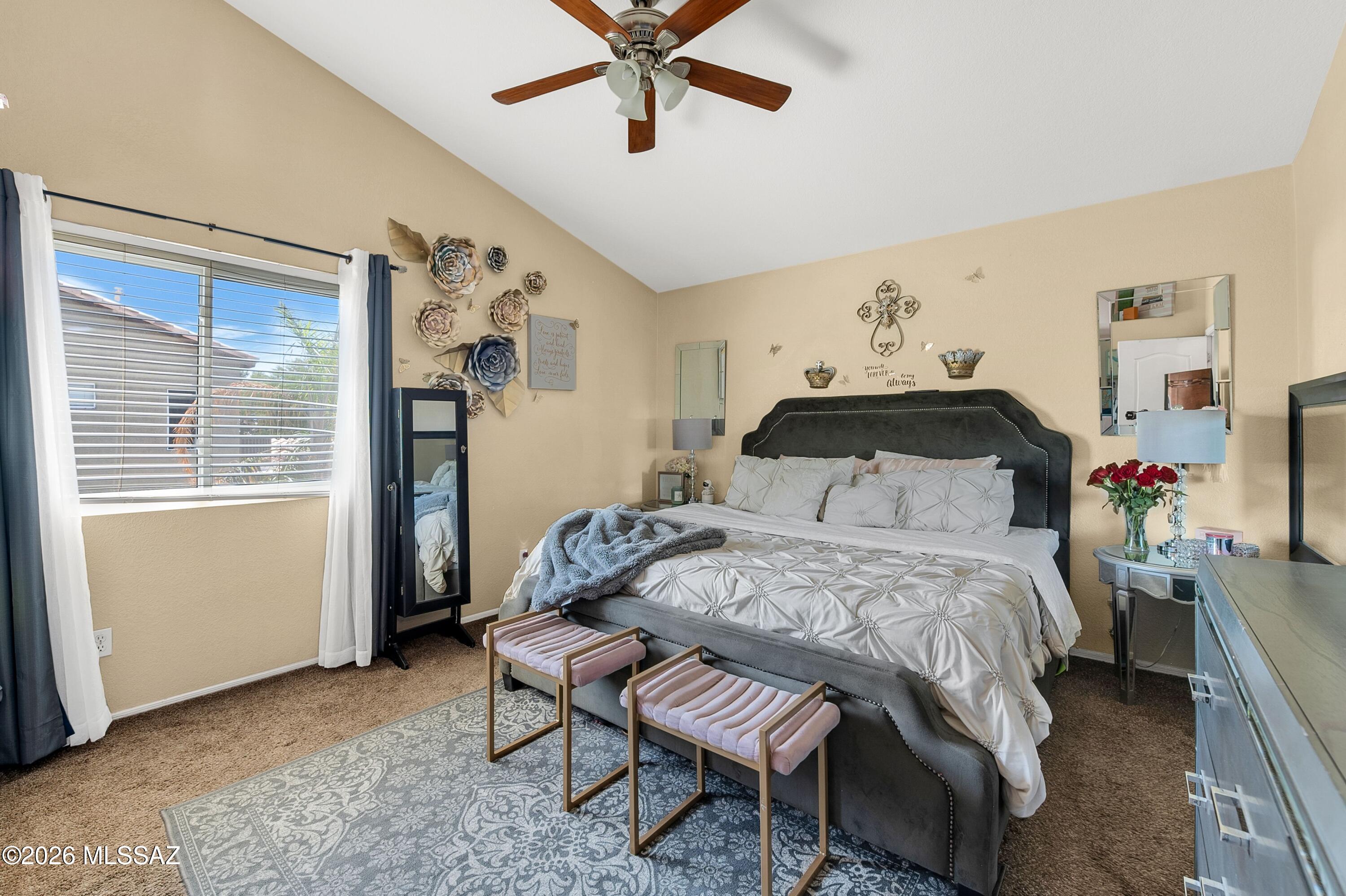 7159 West Maple Ridge Drive Tucson, AZ 85743 - Photo 20 of 42 a bedroom with a bed and a window