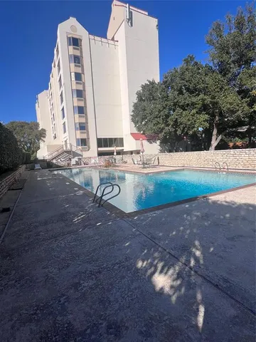 a view of a tall building with a yard