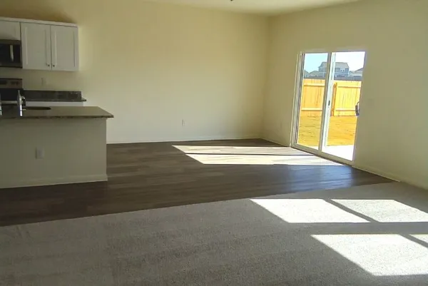 a view of a room with a sink cabinets and a window