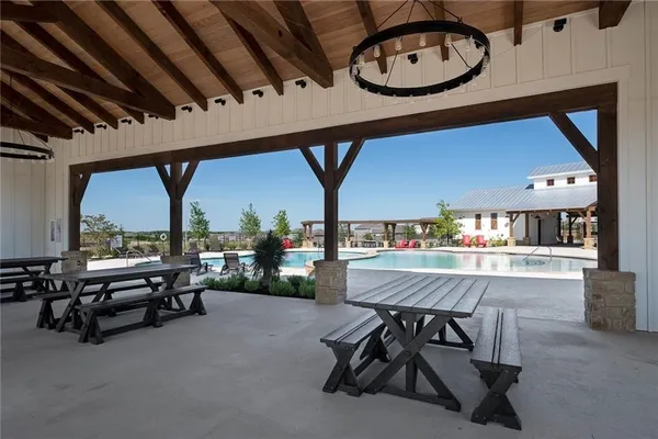 a view of a livingroom with furniture and a large window