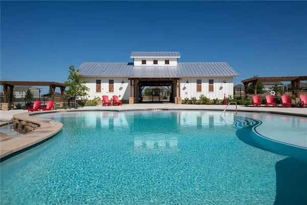a swimming pool view with a outdoor seating