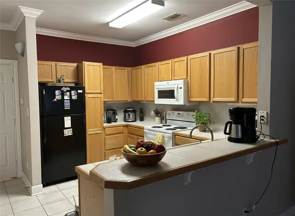 a kitchen with a sink stove and refrigerator