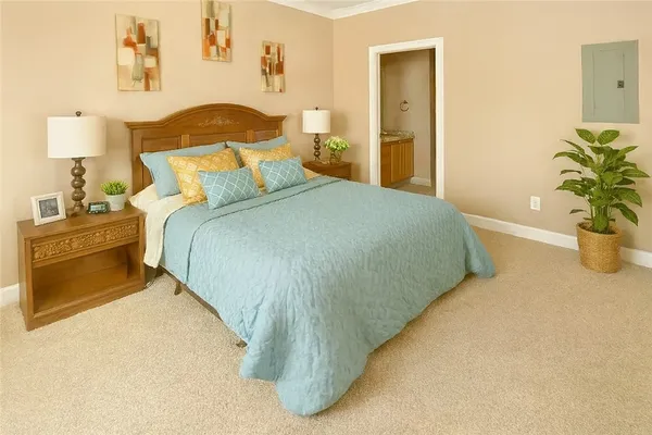 a bedroom with a bed and a potted plant