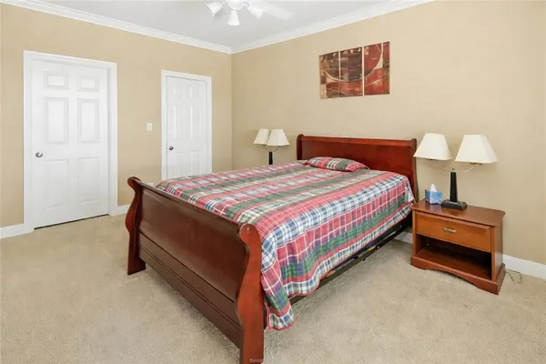 a bedroom with a bed and a lamp