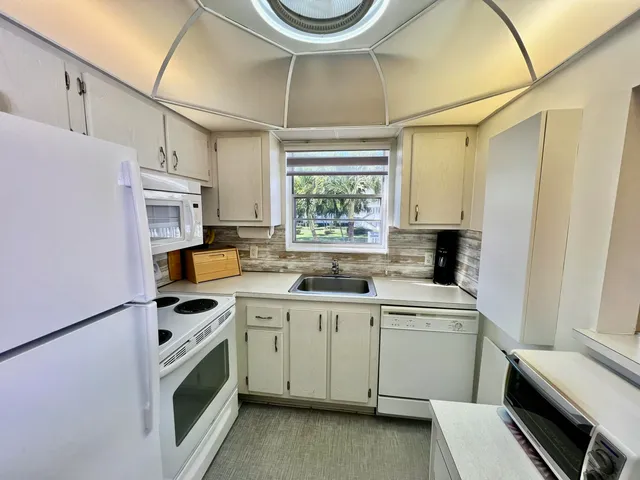 a utility room with sink a washer and dryer
